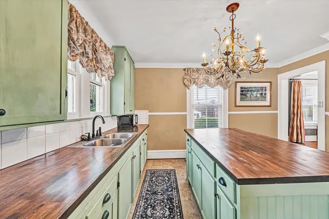 a kitchen with a sink cabinets and outdoor space