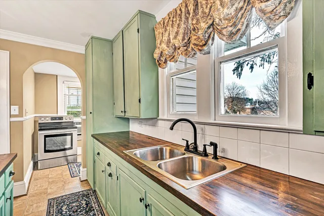 a kitchen with wooden cabinets and a stove top oven