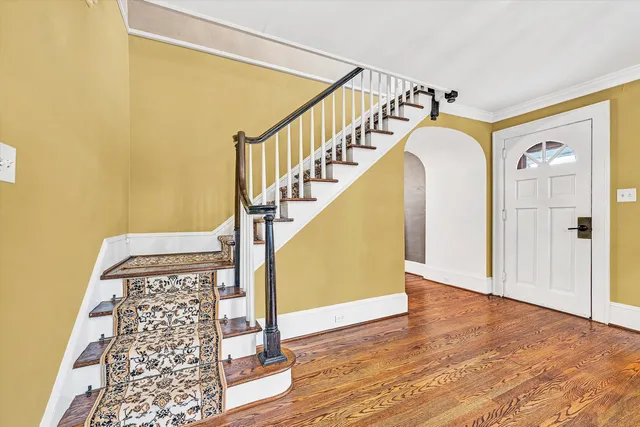 a view of a hallway with wooden floor and a floor to ceiling window