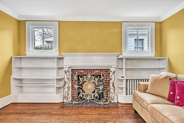 a living room with fireplace furniture and a window