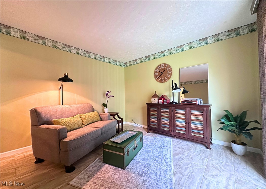 157 Birch Road Painesville, OH 44077 - Photo 13 of 41 Living area featuring baseboards and a textured ceiling