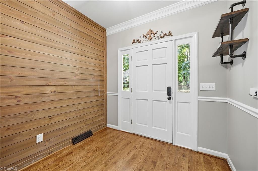 8861 Boylston Road Colfax, NC 27235 - Photo 7 of 50 A bright, thoughtfully designed foyer offers an inviting first impression with custom woodwork and timeless finishes.