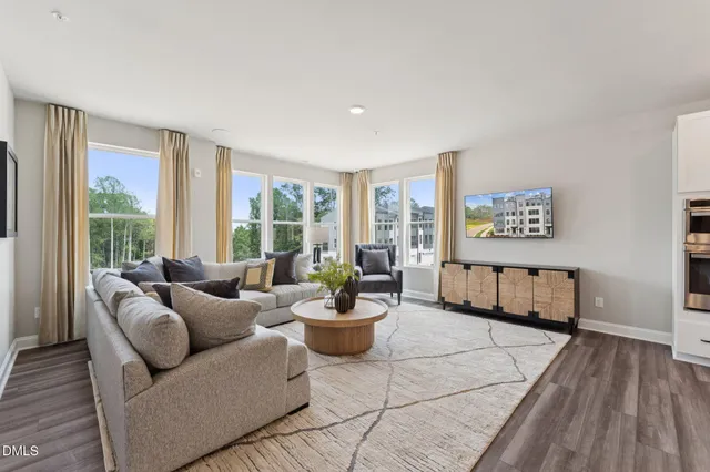 a large kitchen with stainless steel appliances lots of counter space and wooden floor