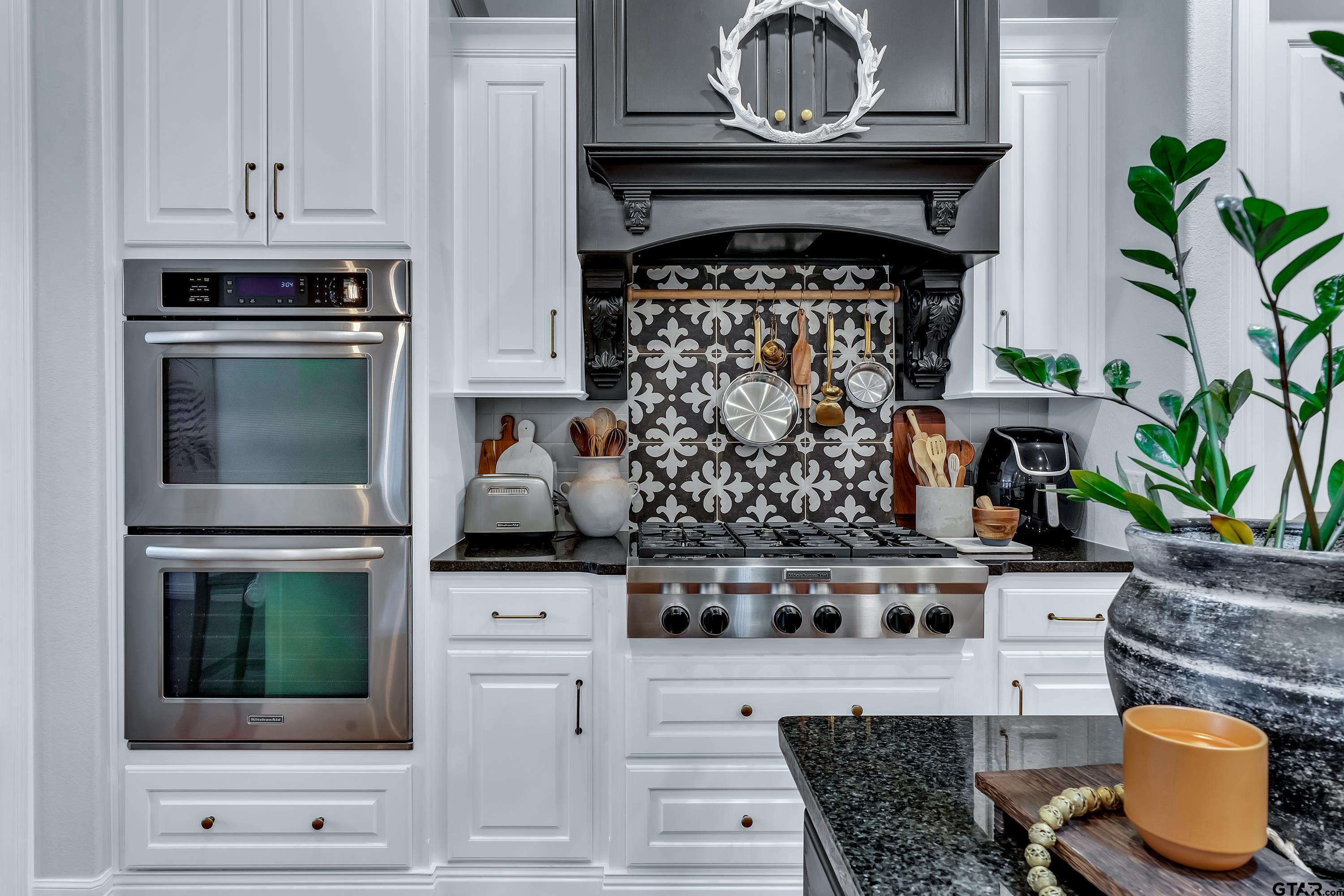 3901 Chase Crest Circle Longview, TX 75605 - Photo 16 of 44 a kitchen with a stove and a microwave