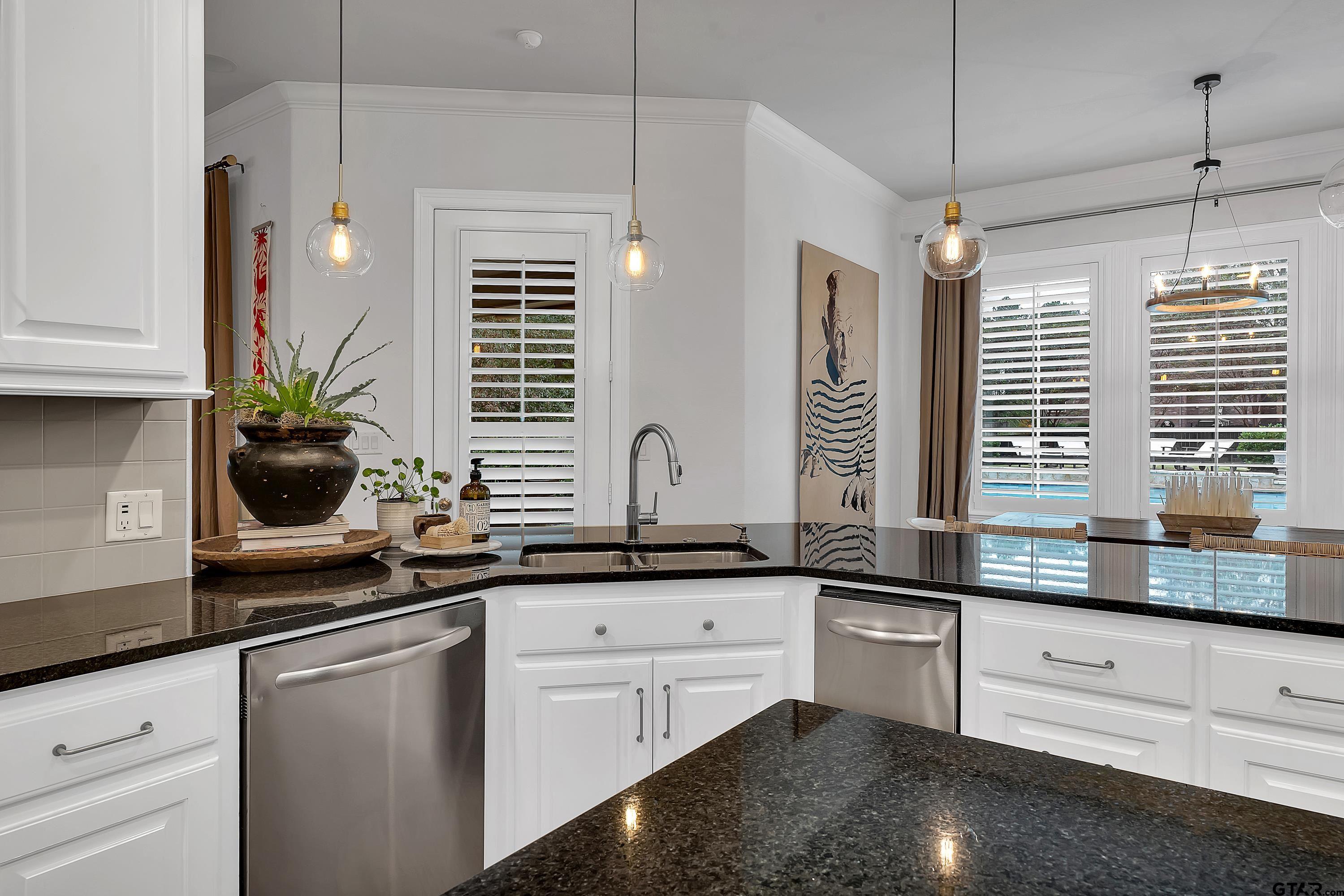 3901 Chase Crest Circle Longview, TX 75605 - Photo 17 of 44 a kitchen with granite countertop a sink and white cabinets