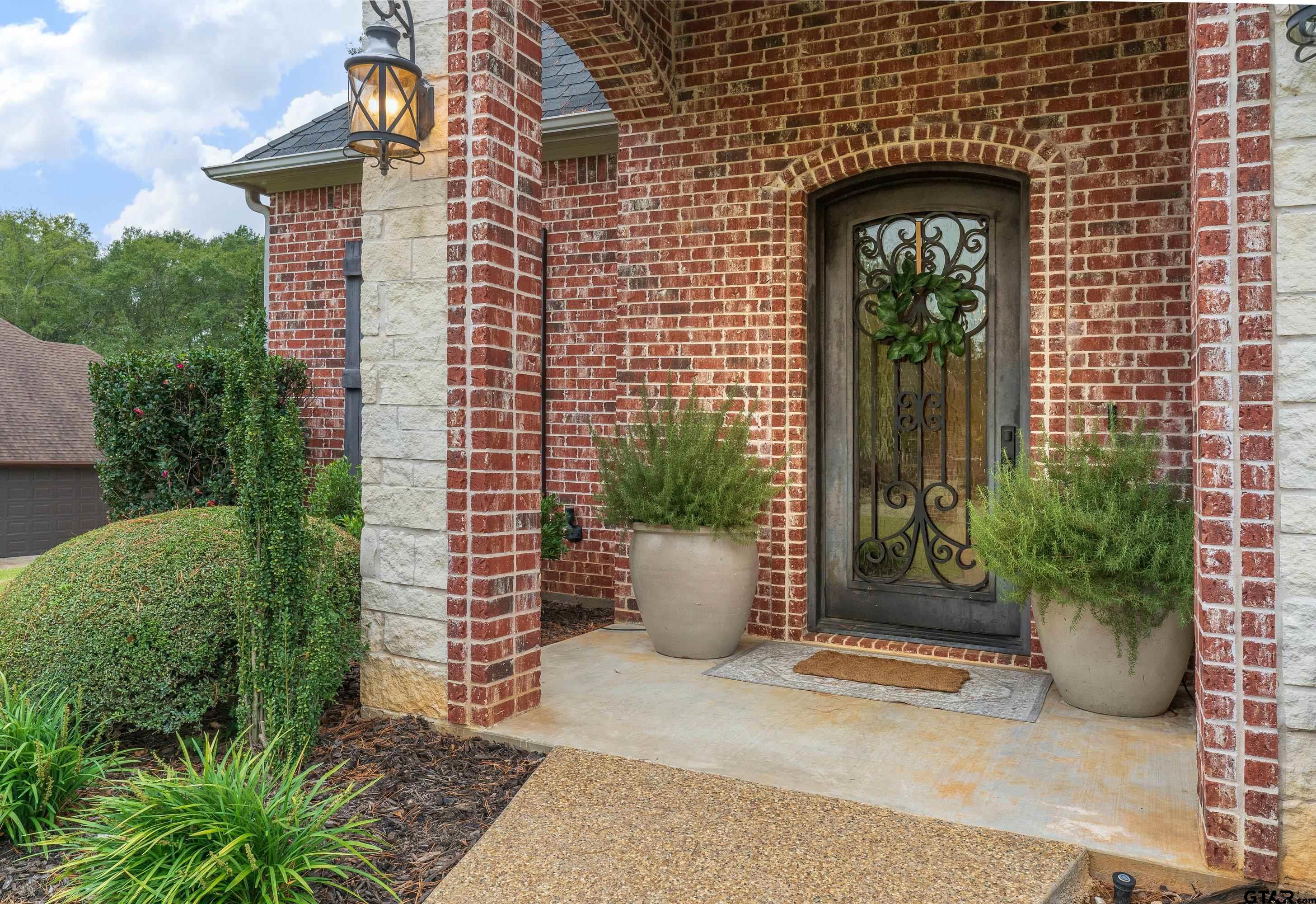 3901 Chase Crest Circle Longview, TX 75605 - Photo 2 of 44 a front view of a house with potted plants