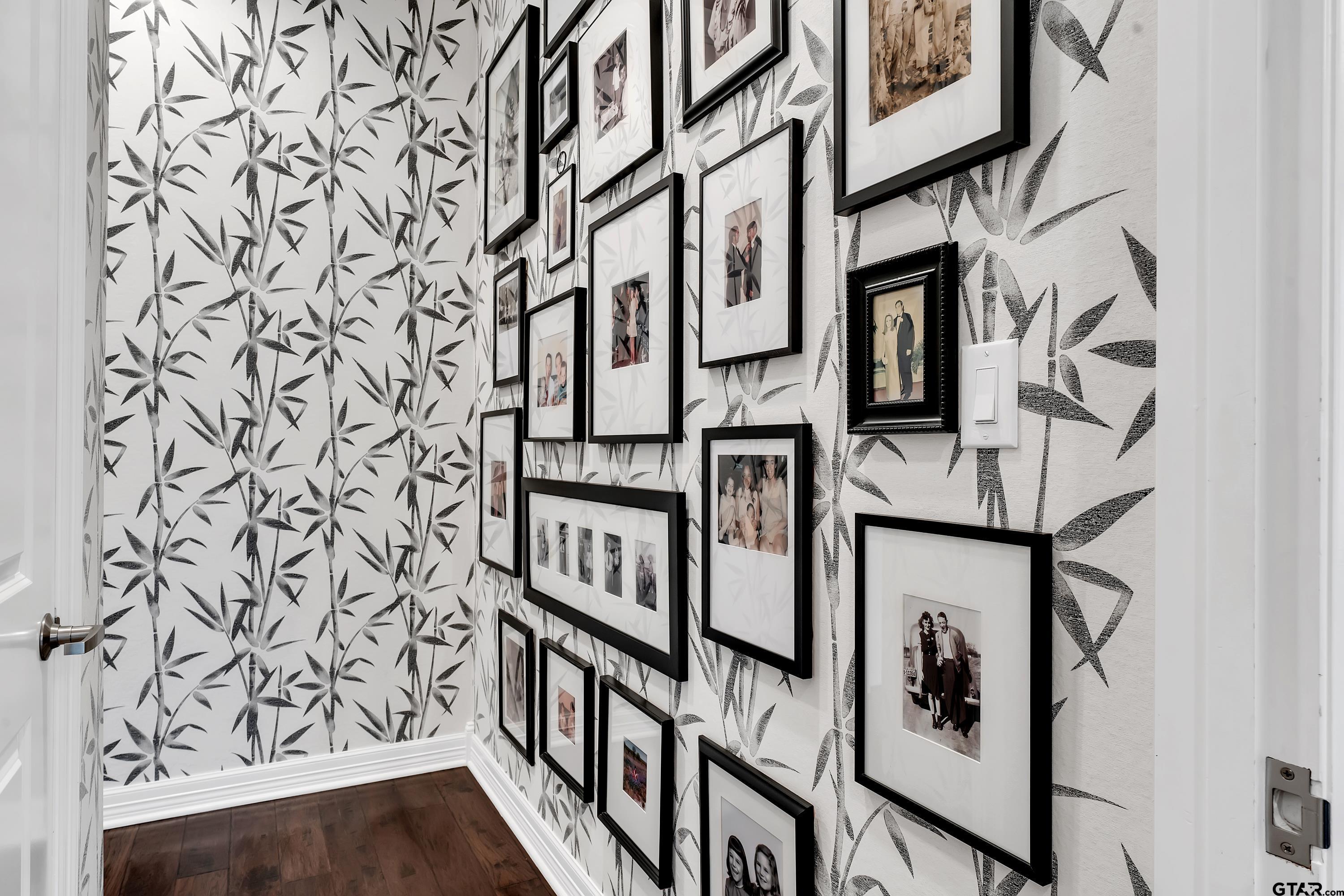 3901 Chase Crest Circle Longview, TX 75605 - Photo 23 of 44 wooden floor with a white wall and a painting on the wall