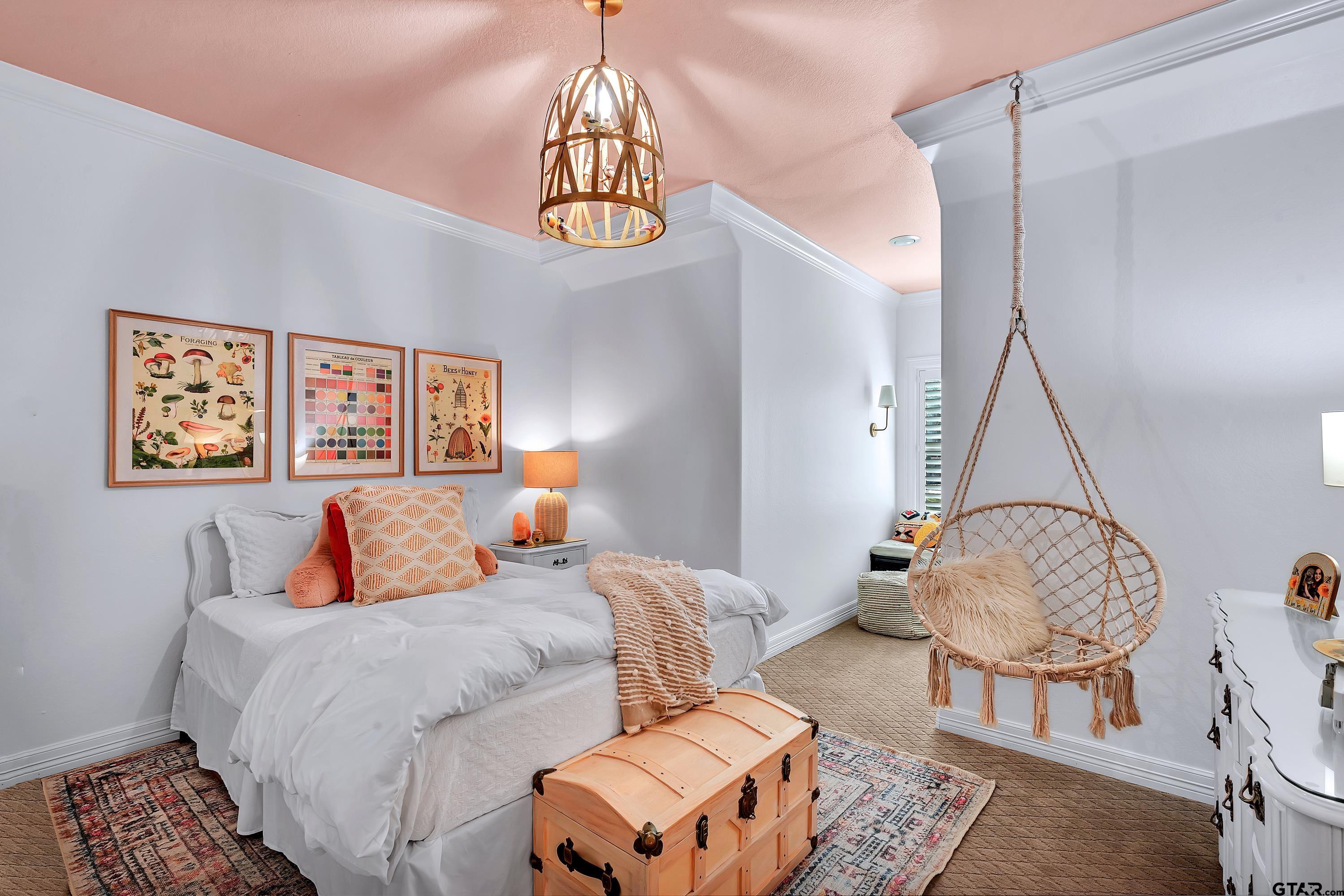 3901 Chase Crest Circle Longview, TX 75605 - Photo 33 of 44 a bedroom with a bed a lamp and a chandelier