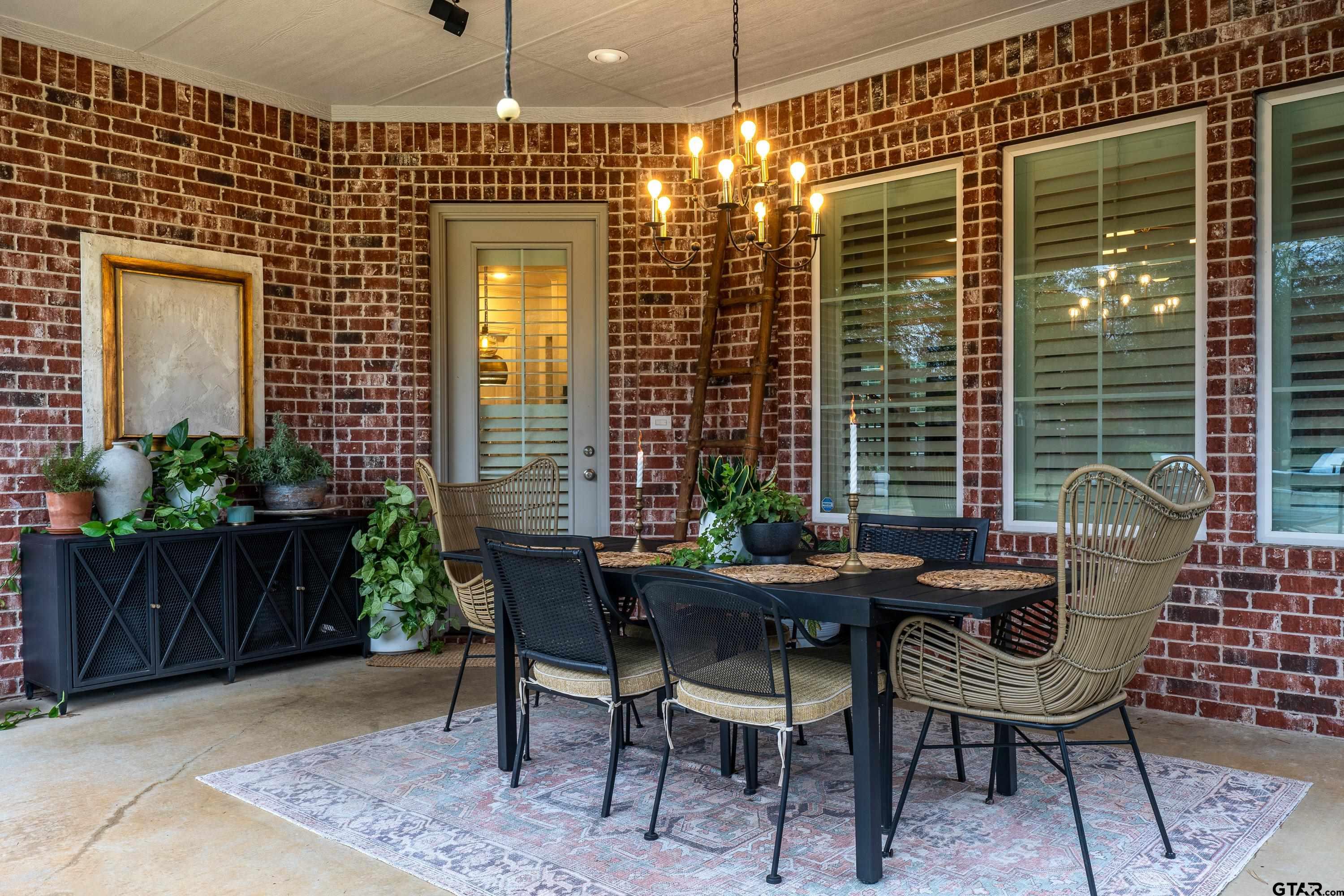 3901 Chase Crest Circle Longview, TX 75605 - Photo 37 of 44 a patio with table and chairs and potted plants