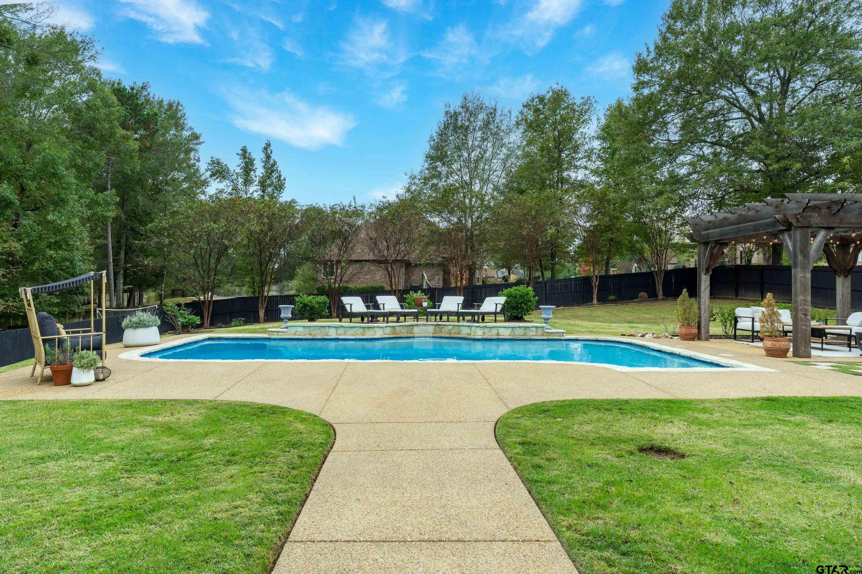 3901 Chase Crest Circle Longview, TX 75605 - Photo 39 of 44 a view of a swimming pool with a yard