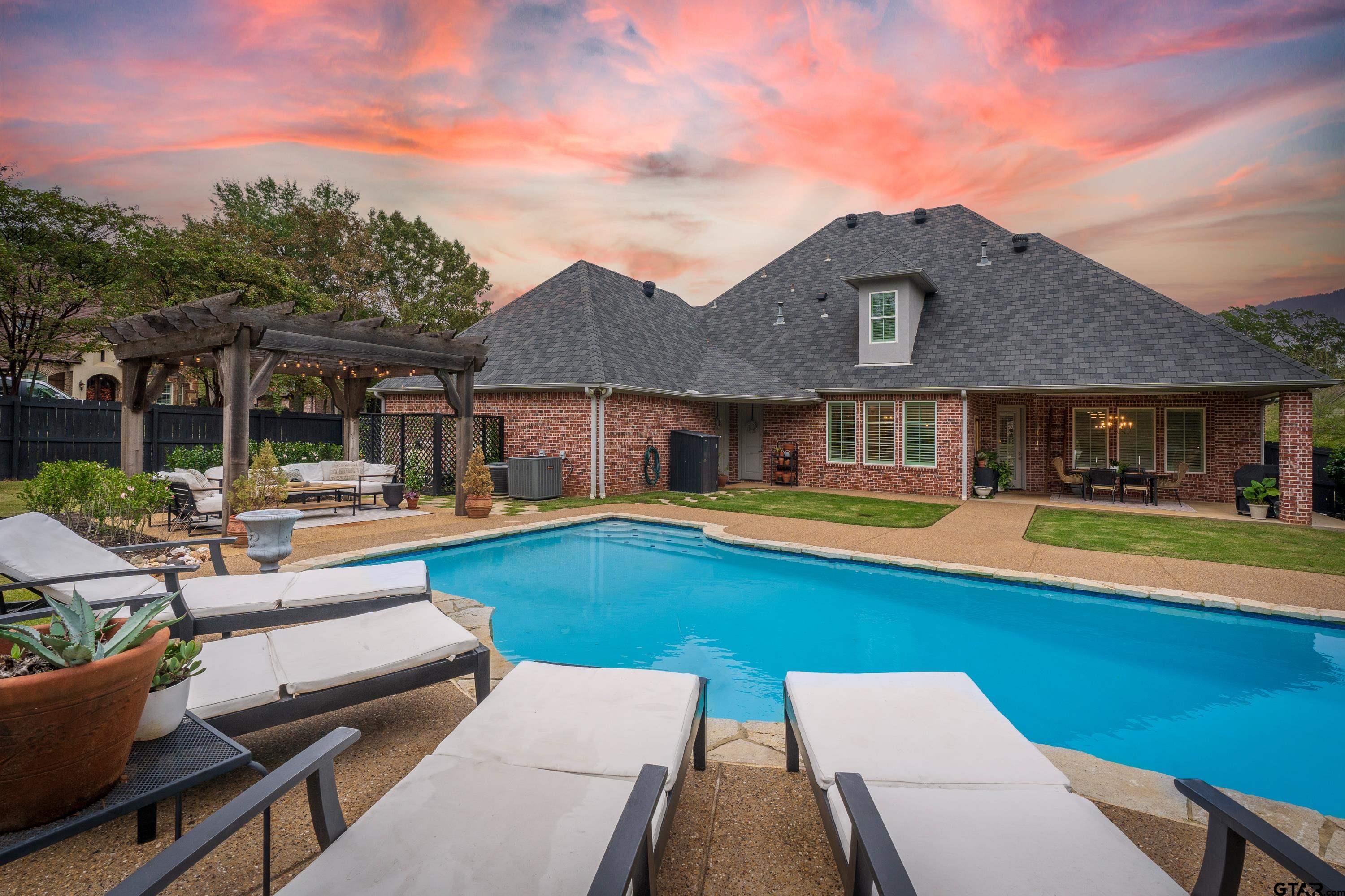 3901 Chase Crest Circle Longview, TX 75605 - Photo 42 of 44 a view of a house with swimming pool and a chairs