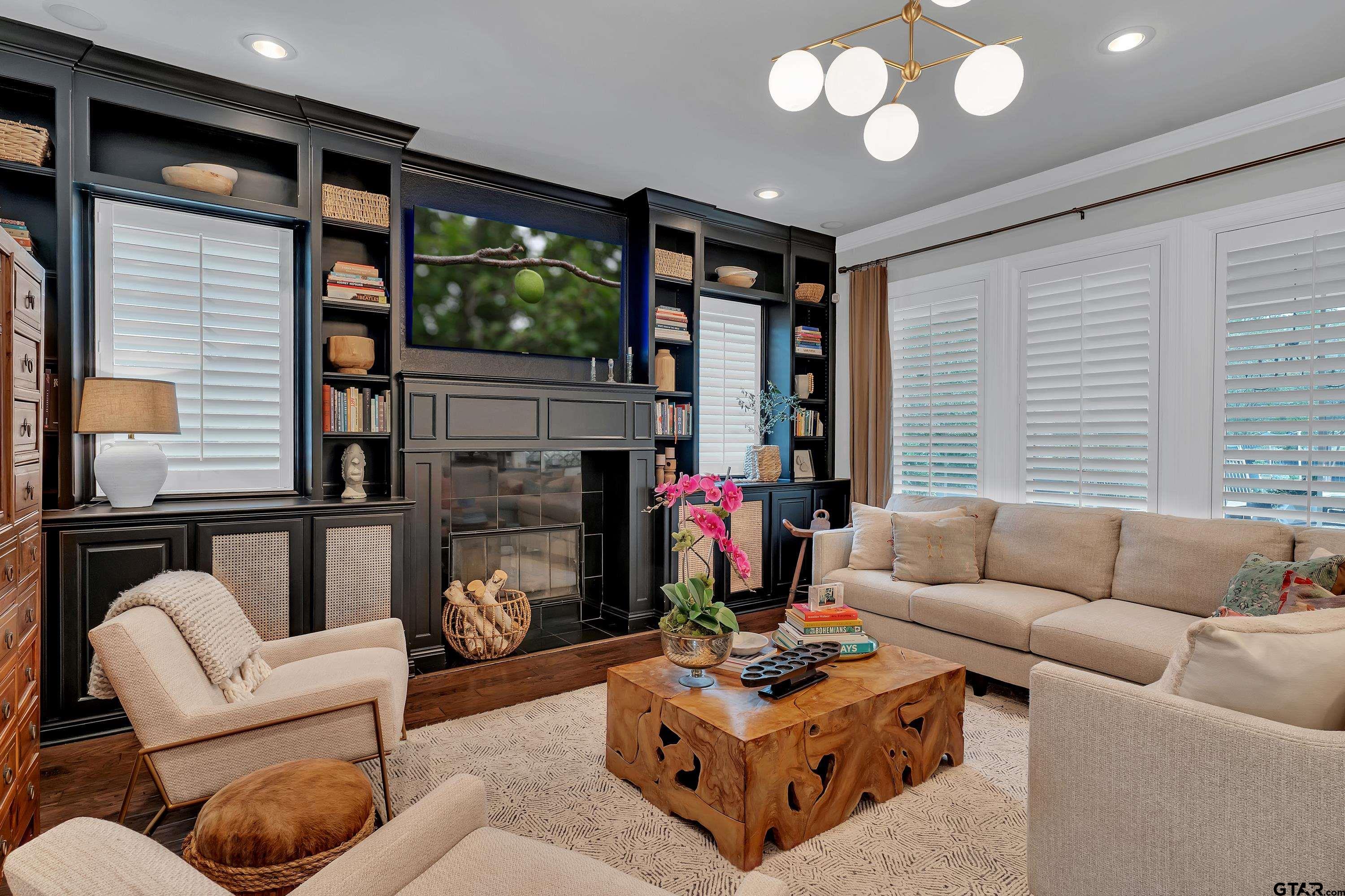 3901 Chase Crest Circle Longview, TX 75605 - Photo 8 of 44 a living room with furniture a fireplace and a flat screen tv