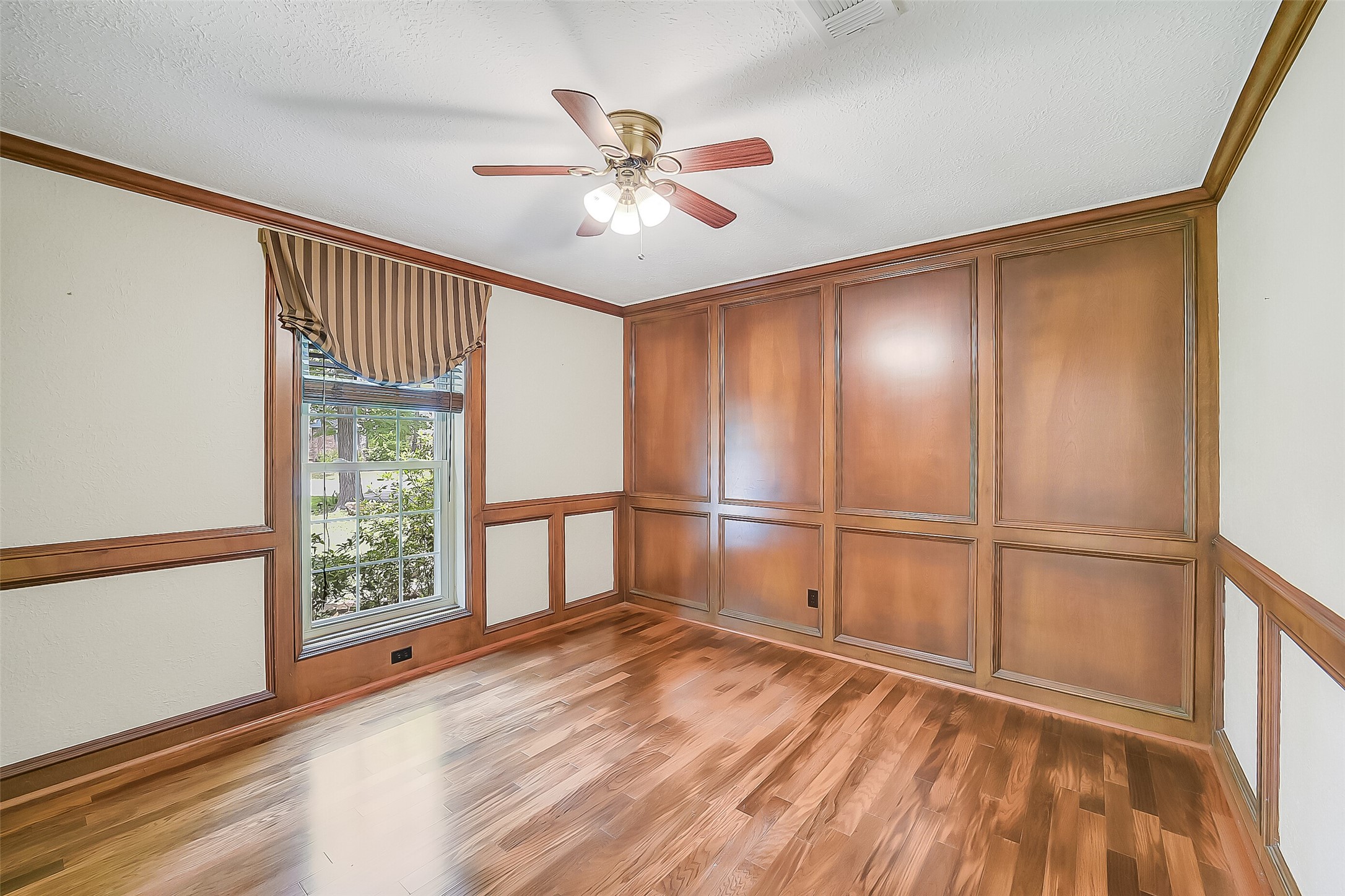 9519 Oxted Lane Spring, TX 77379 - Photo 15 of 40 an empty room with wooden floor fan and windows