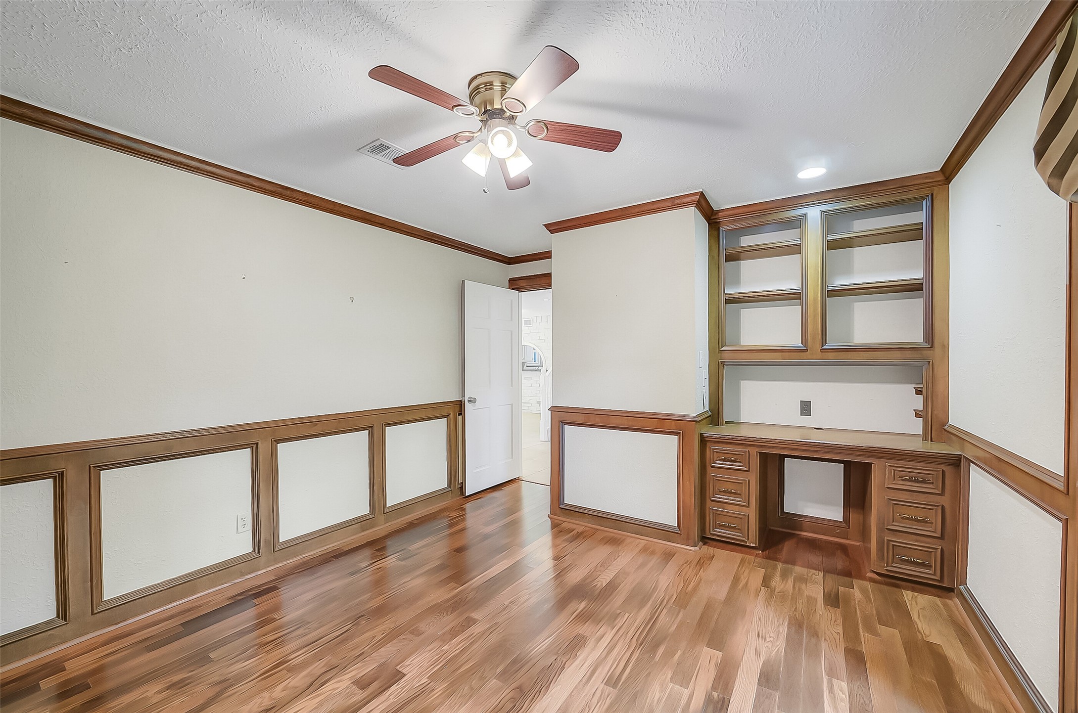9519 Oxted Lane Spring, TX 77379 - Photo 16 of 40 a view of an empty room with window and wooden floor