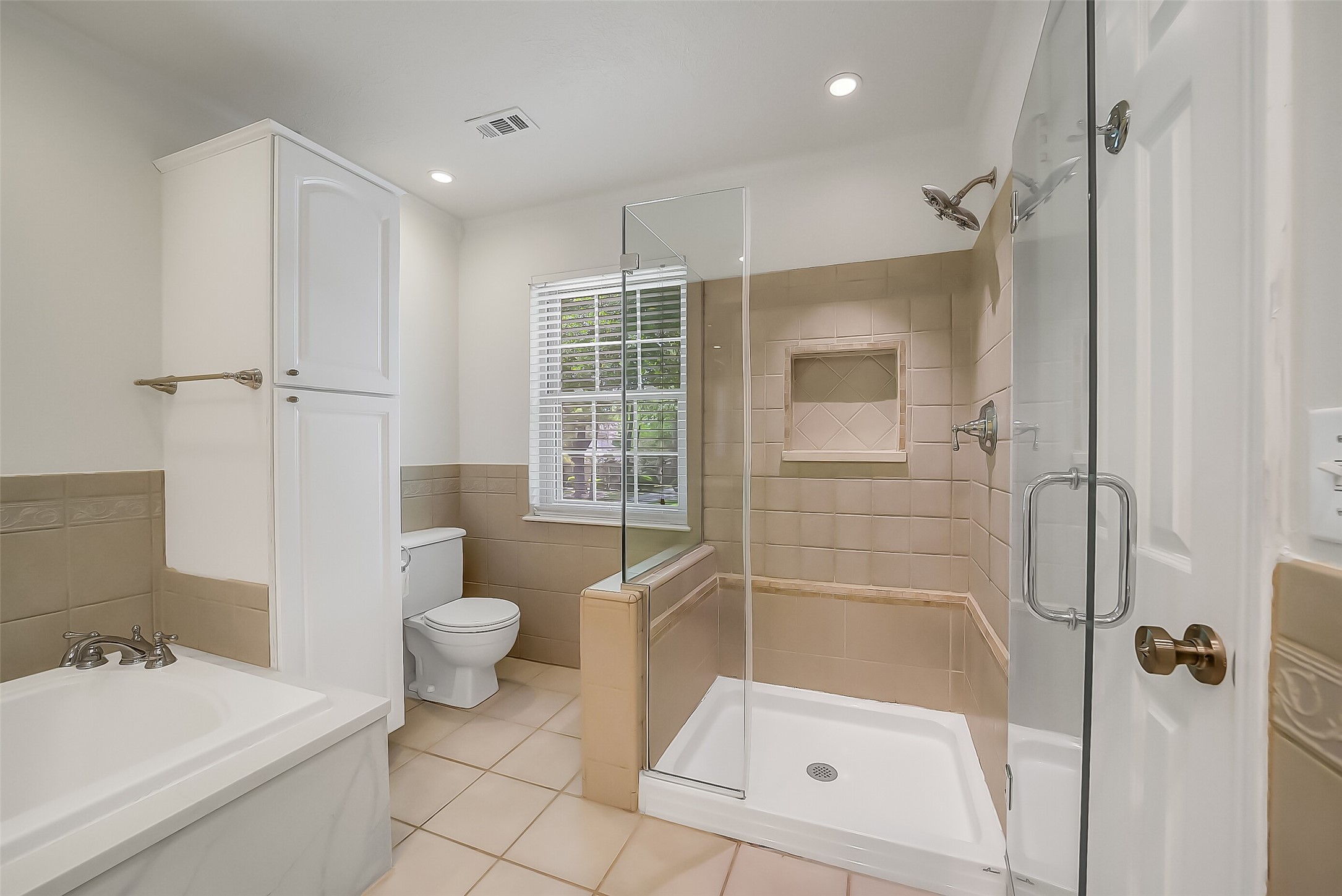 9519 Oxted Lane Spring, TX 77379 - Photo 19 of 40 a bathroom with a sink a toilet and shower