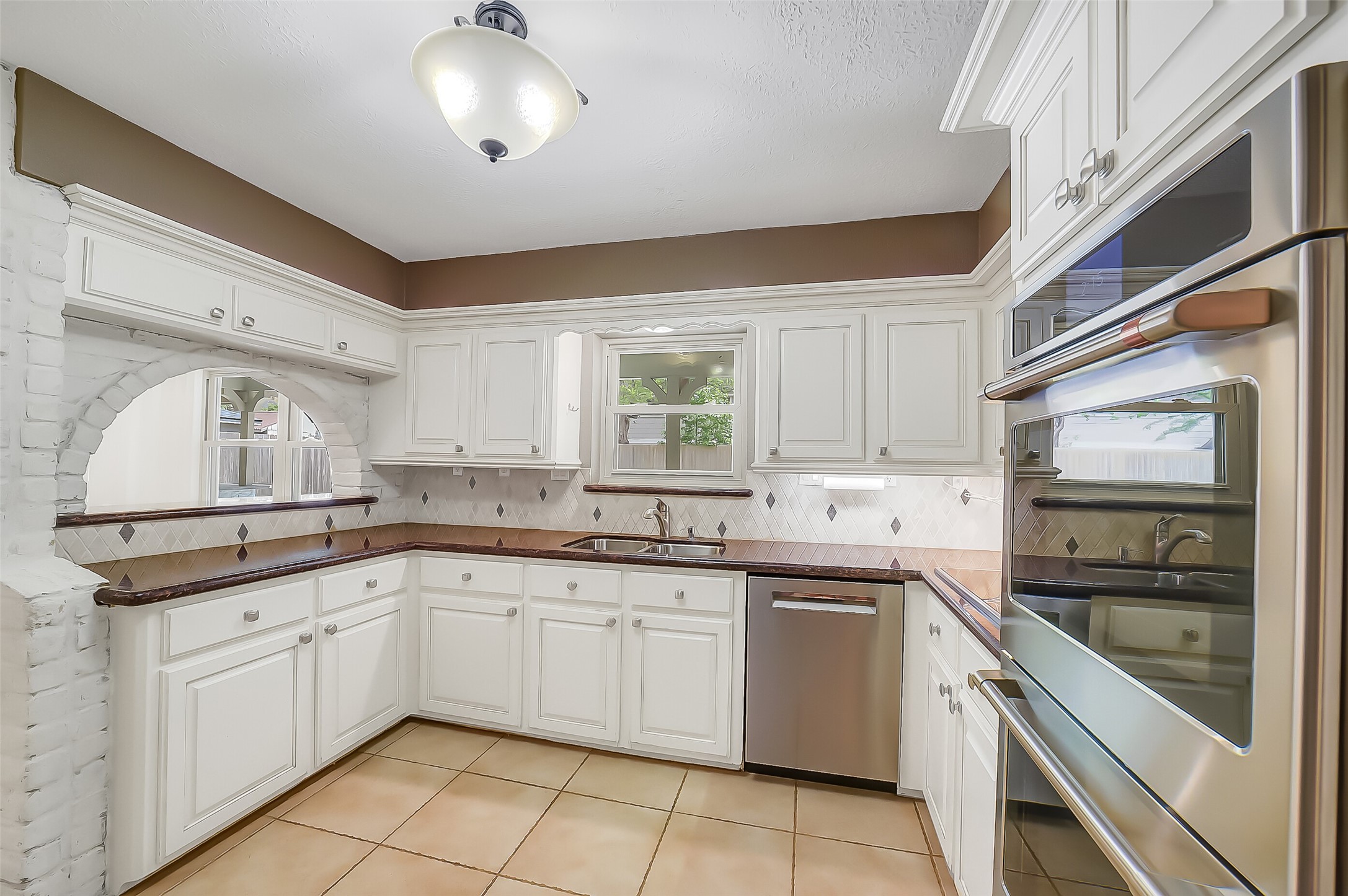9519 Oxted Lane Spring, TX 77379 - Photo 10 of 40 a kitchen with a sink stove and cabinets