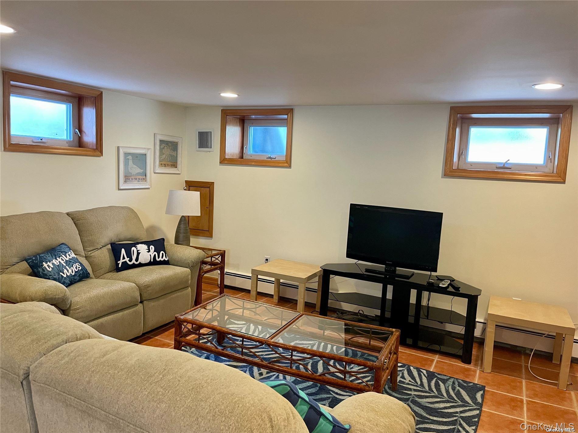 89 Lynbrook Avenue Point Lookout, NY 11569 - Photo 14 of 19 a living room with furniture and a flat screen tv