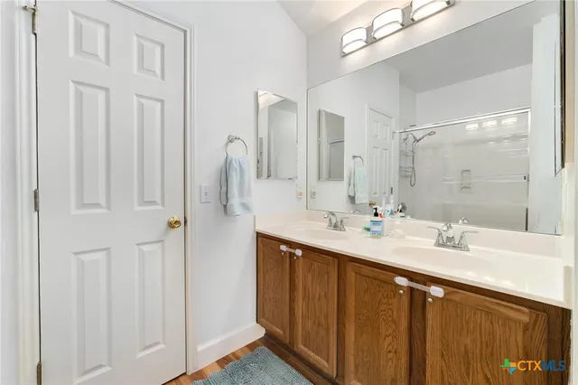a bathroom with a double vanity sink and mirror