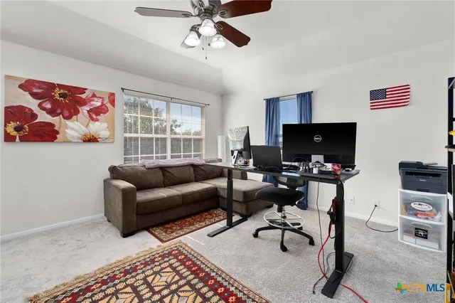 a livingroom with workspace and a couch