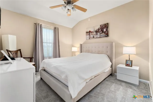 a bed room with a bed and a chandelier