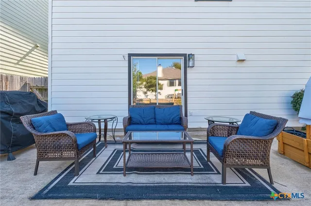 a view of two chairs in the patio