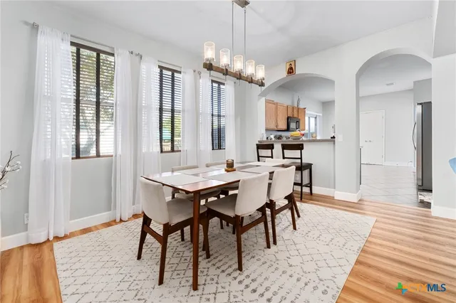 a view of a dining room with furniture and window