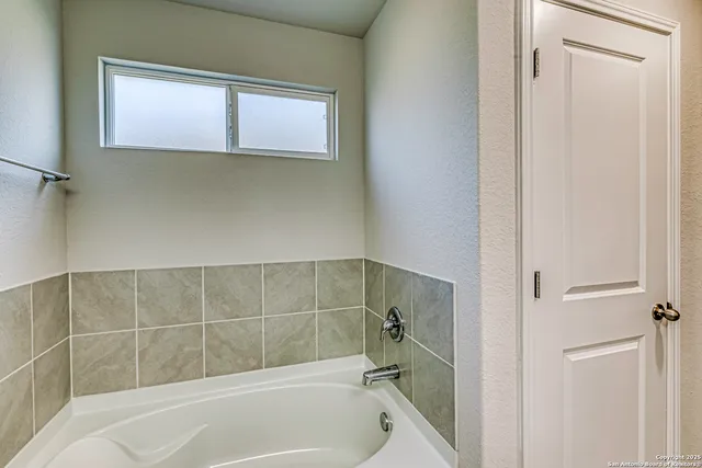 a view of walk in closet with clothes