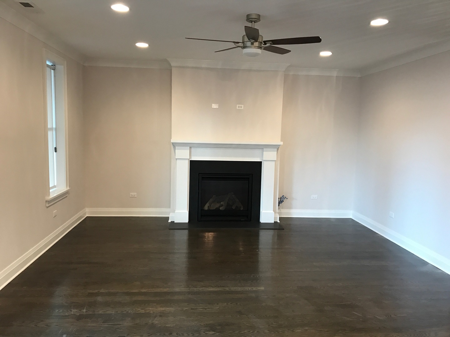 1843 West Irving Park Road, Unit 3 Chicago, IL 60613 - Photo 20 of 34 an empty room with wooden floor a fireplace and windows