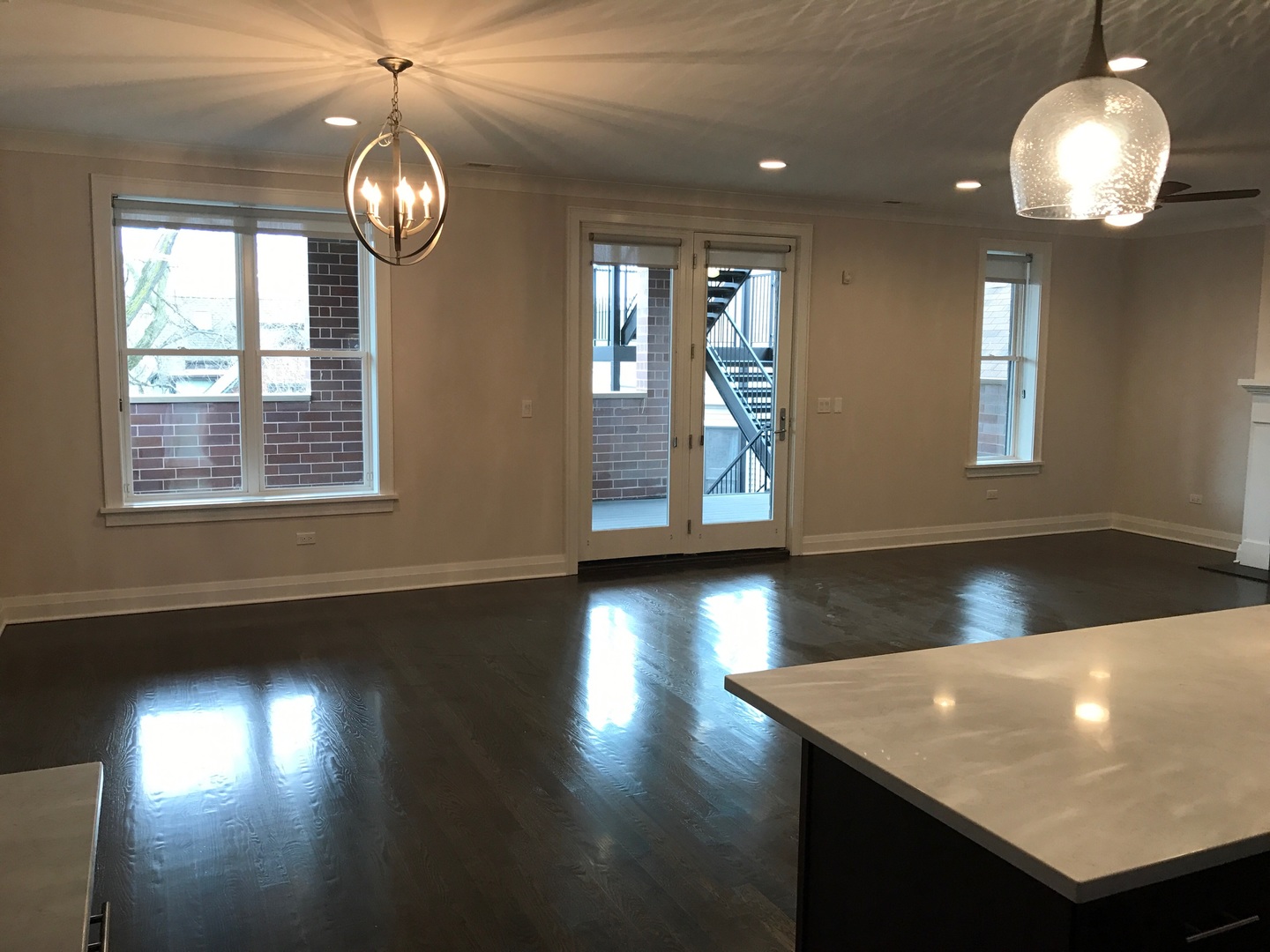 1843 West Irving Park Road, Unit 3 Chicago, IL 60613 - Photo 23 of 34 a view of livingroom with furniture wooden floor and chandelier