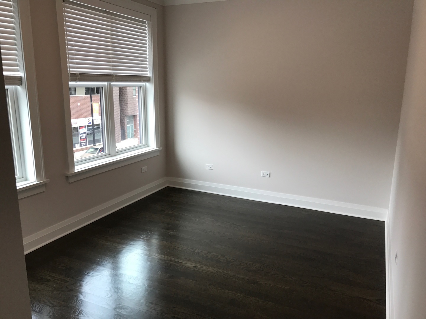 1843 West Irving Park Road, Unit 3 Chicago, IL 60613 - Photo 5 of 34 an empty room with wooden floor and windows