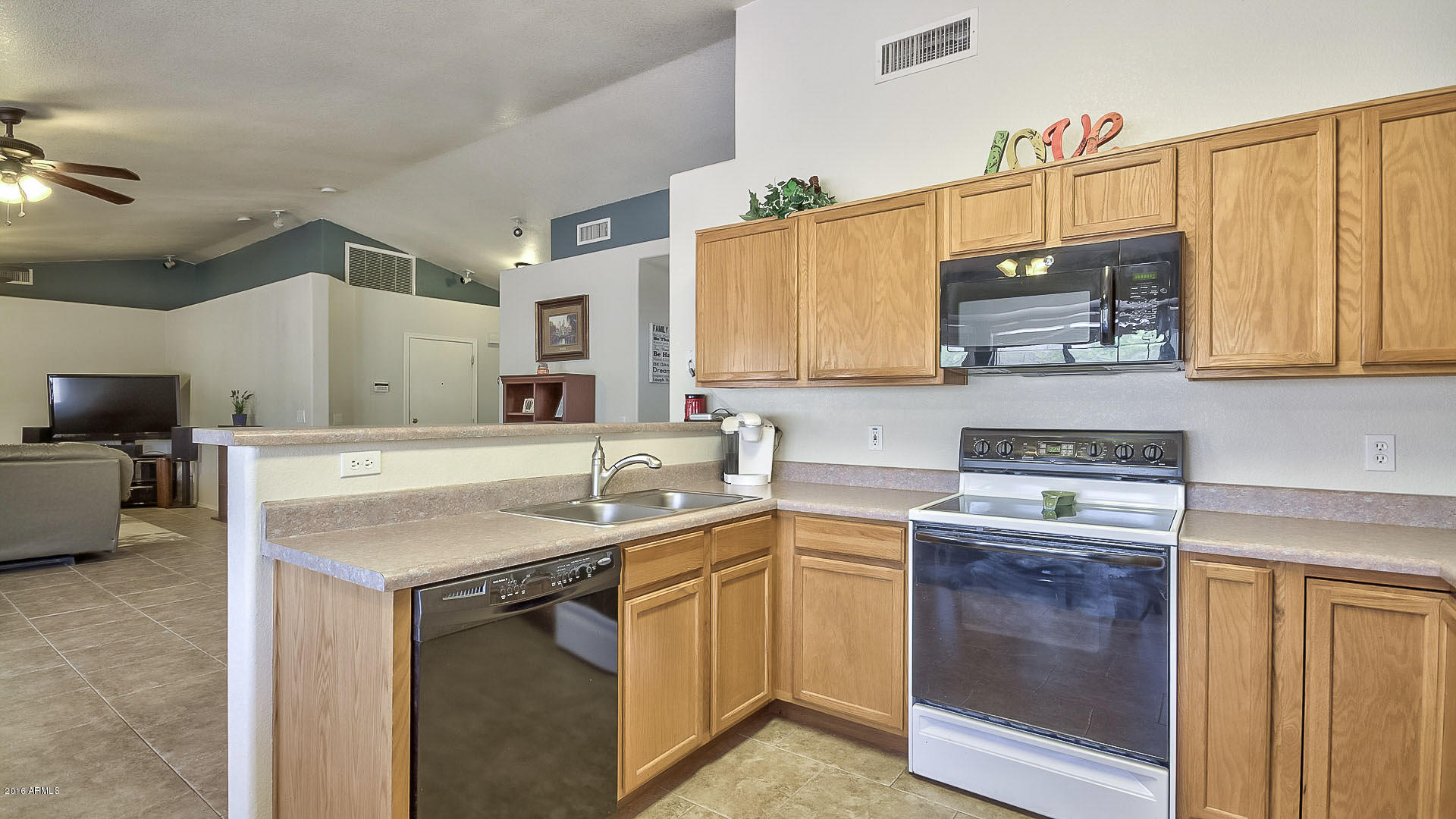 2001 South Mountain View Road Apache Junction, AZ 85119 - Photo 25 of 46 a kitchen with a sink stove and microwave