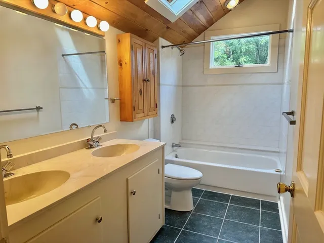 a bathroom with a sink toilet a mirror and shower