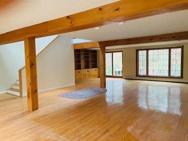 a view of an entryway with wooden floor and door
