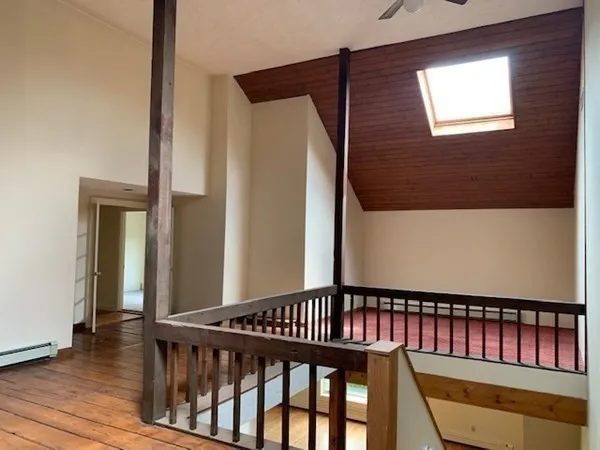 a view of staircase with railing and a window