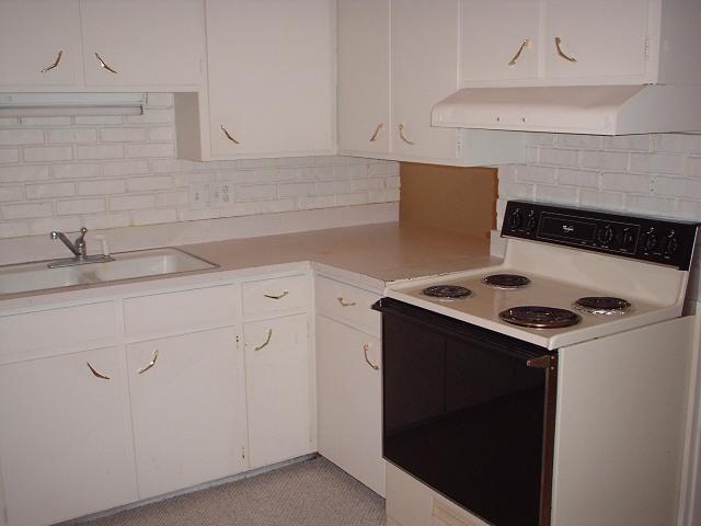 5105 Susan Drive Amarillo, TX 79110 - Photo 5 of 8 a kitchen with granite countertop white cabinets and white appliances