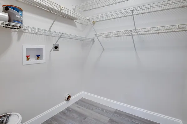 an empty room with closet and fan