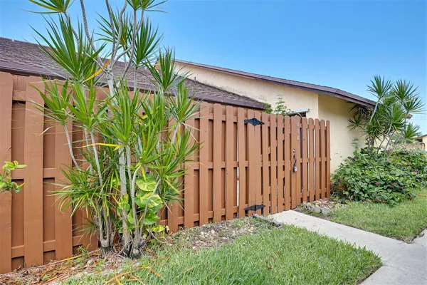 a view of a house with a yard and plants