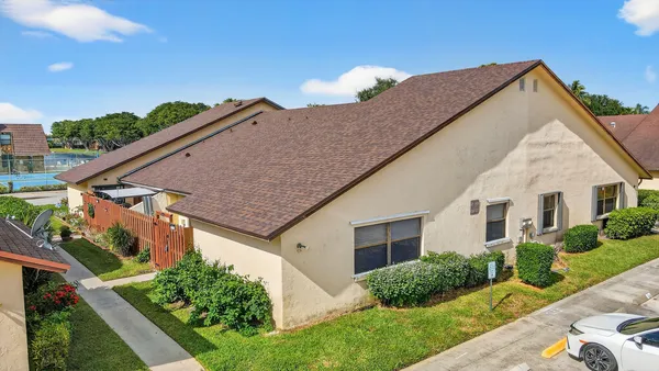 an aerial view of residential houses with outdoor space