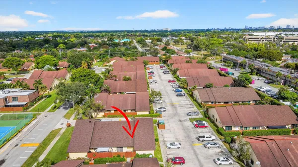 an aerial view of residential houses with outdoor space and swimming pool