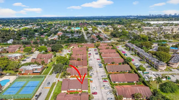 an aerial view of residential houses with outdoor space and street view