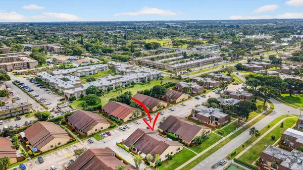 a aerial view of a house with a yard and potted plants