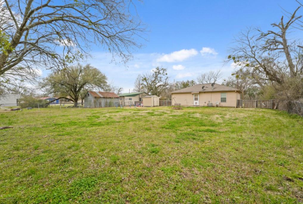 209 Mill Street Lone Oak, TX 75453 - Photo 24 of 29 View of yard with a storage unit, an outdoor structure, and fence private yard