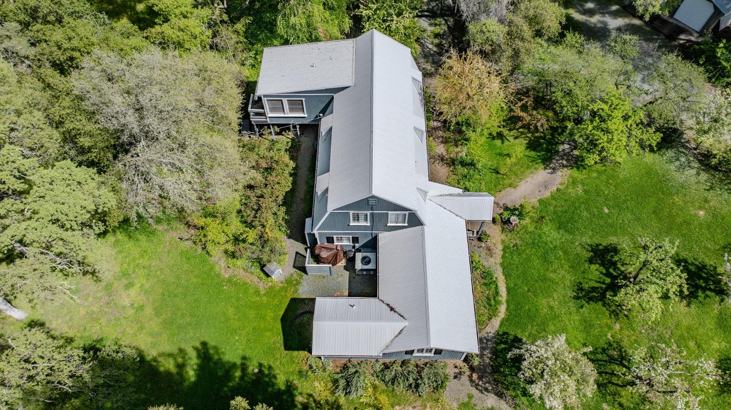 an aerial view of a house with a yard