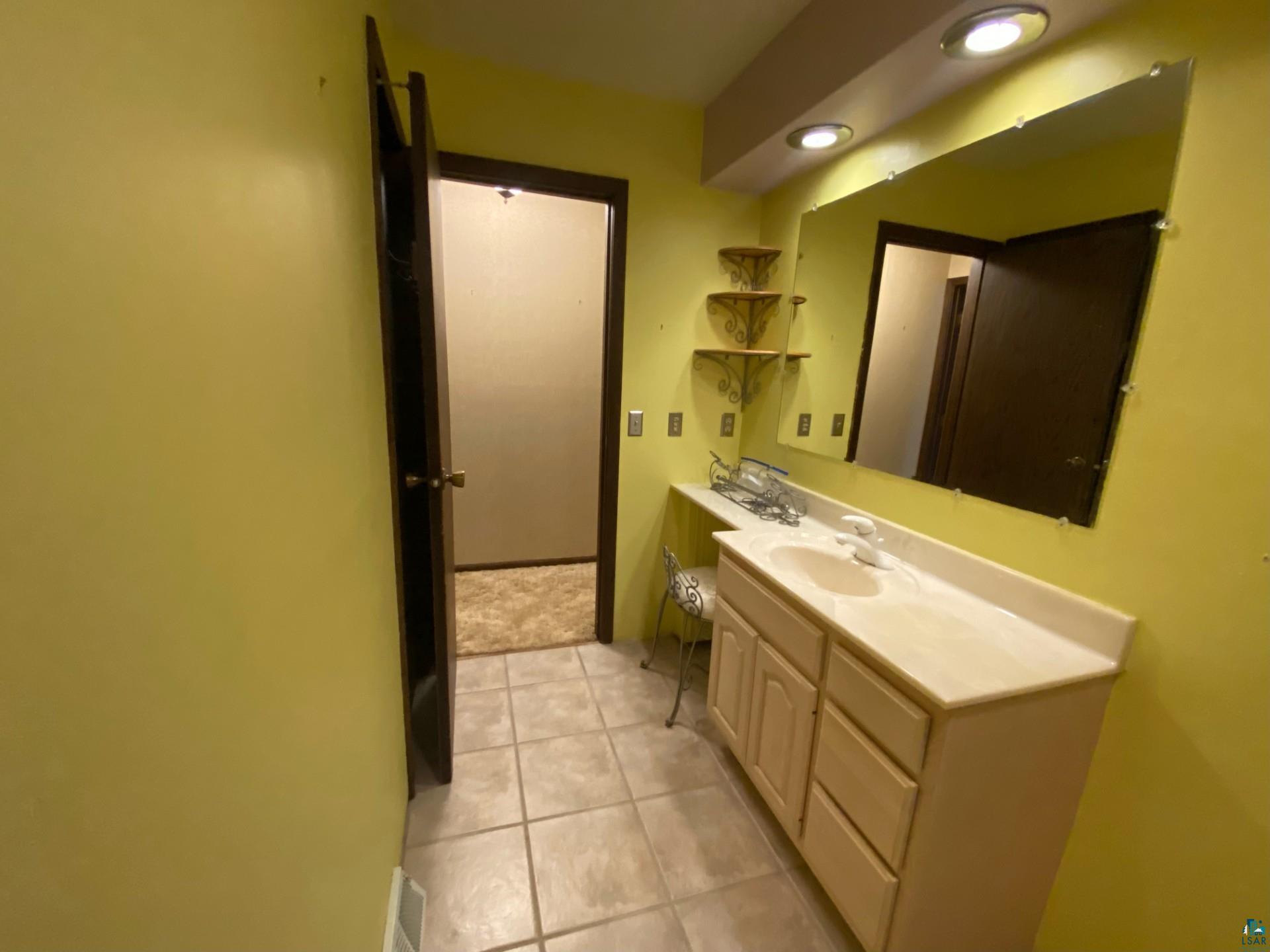 11316 East Timber Ridge Drive Lake Nebagamon, WI 54849 - Photo 18 of 27 Bathroom with vanity and tile patterned floors