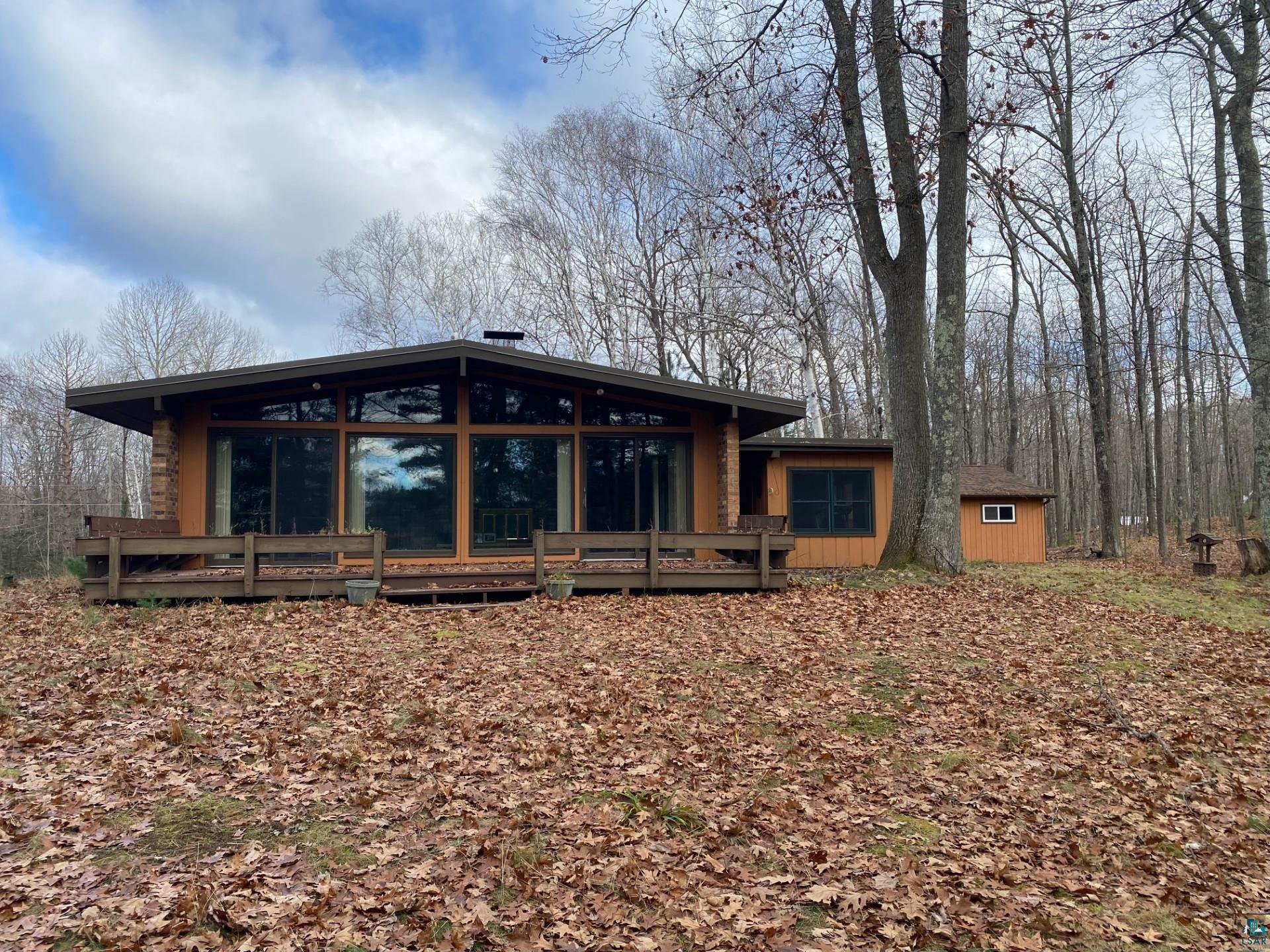11316 East Timber Ridge Drive Lake Nebagamon, WI 54849 - Photo 2 of 27 Rear view of house featuring a deck