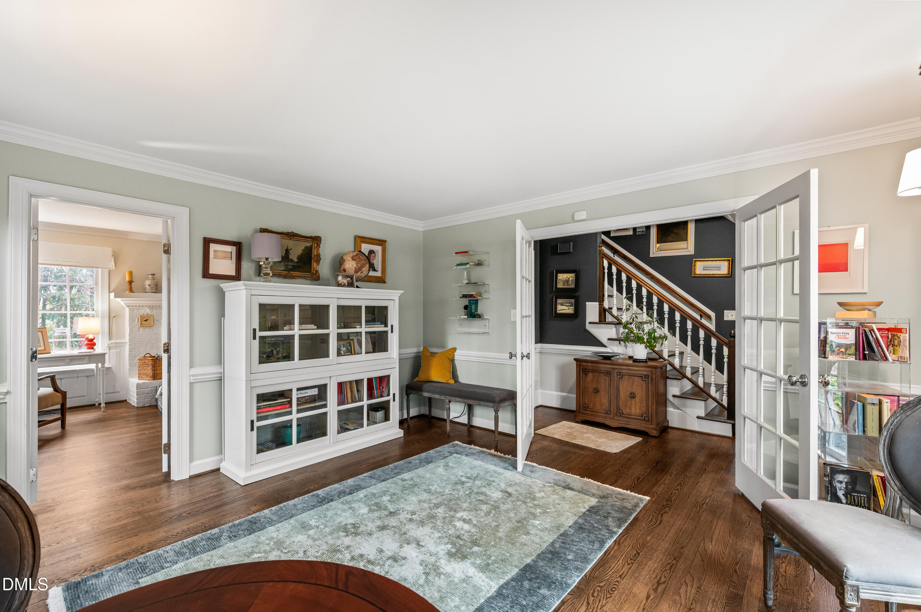 8304 North Crestwyck Court Raleigh, NC 27615 - Photo 17 of 40 a living room with wooden floor and a book shelf