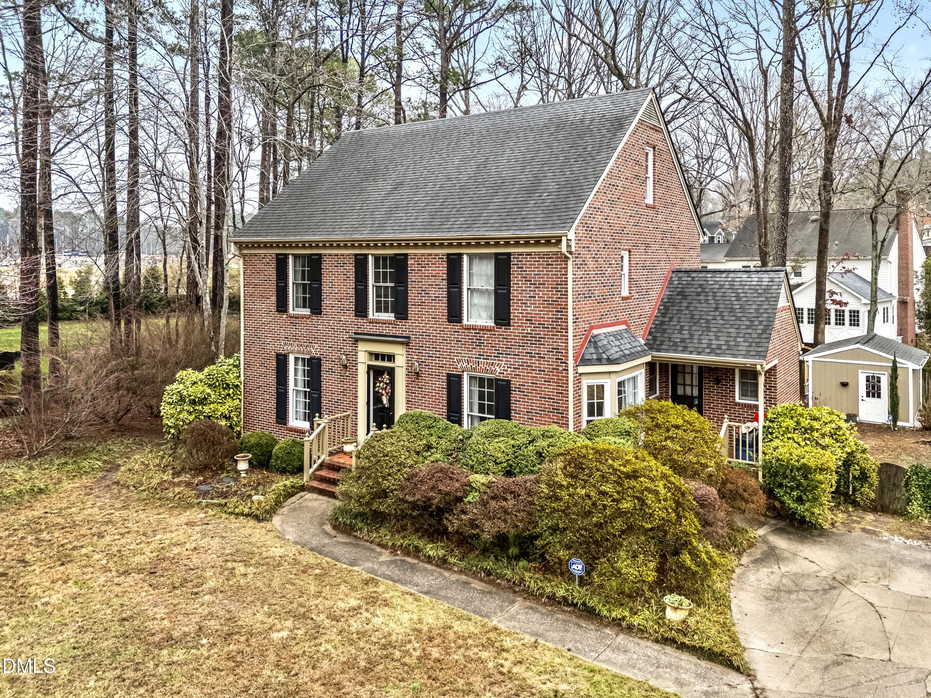 8304 North Crestwyck Court Raleigh, NC 27615 - Photo 3 of 40 a front view of a house with a garden