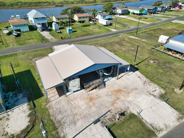 an aerial view of a house with a yard