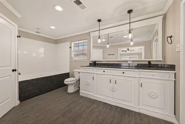 a spacious bathroom with a granite countertop sink and a mirror