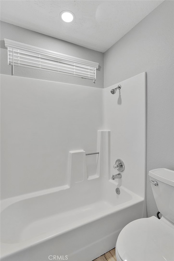 11076 Wagon Train Road Pinon Hills, CA 92371 - Photo 15 of 24 a bathroom with a toilet and a bathtub